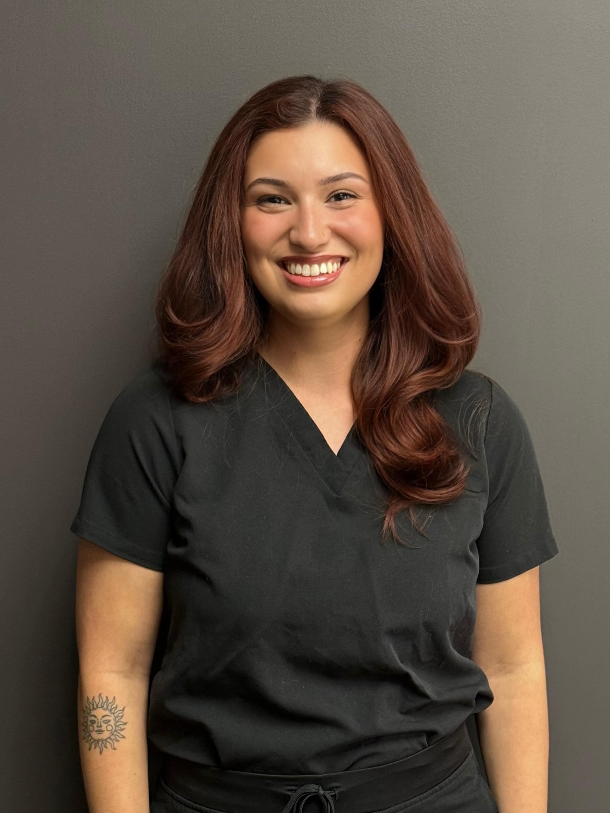 Professional and friendly staff member at Carmel Dental Care, ready to assist patients with their dental needs and provide exceptional care.