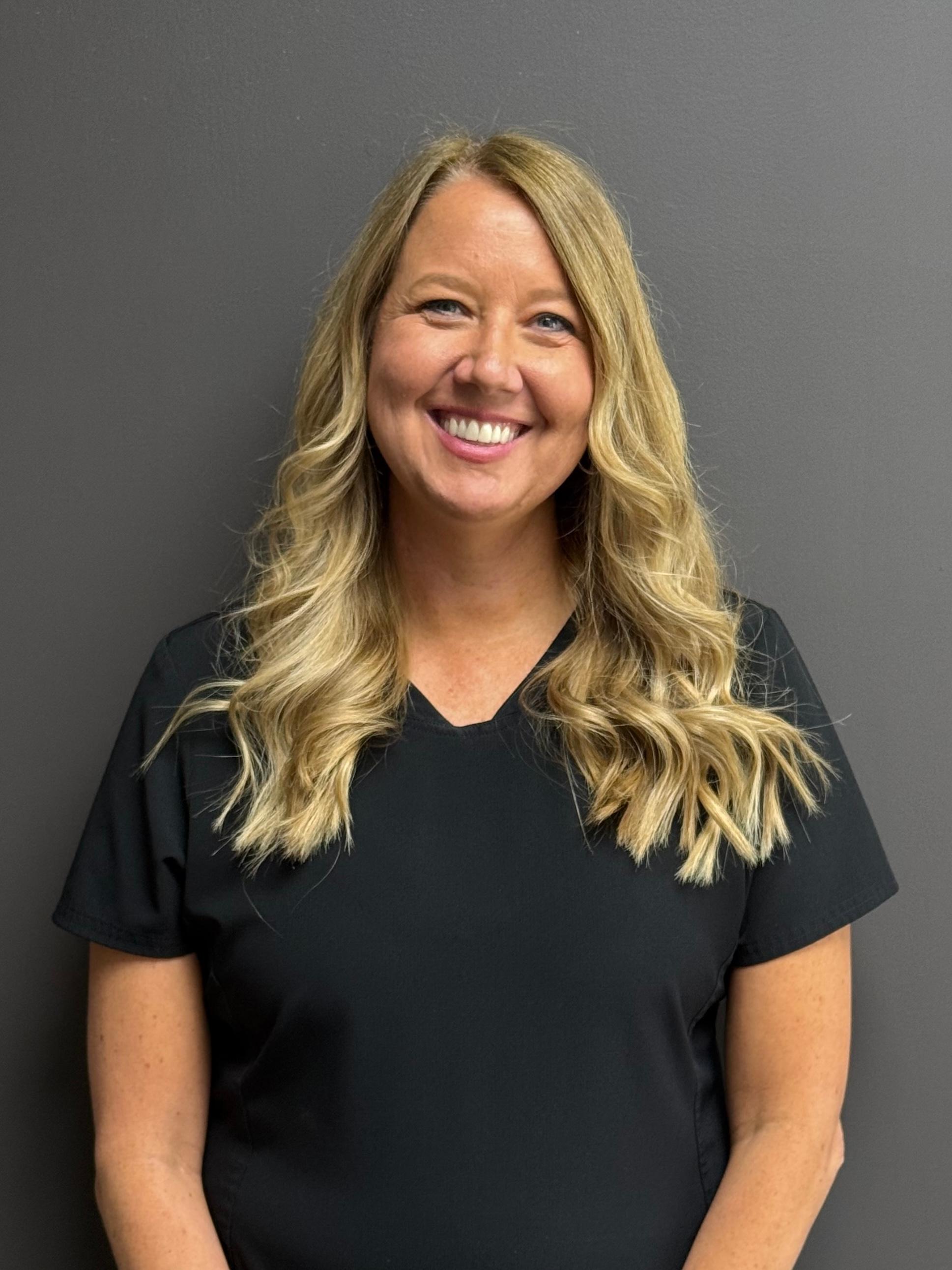 Professional and friendly staff member at Carmel Dental Care, ready to assist patients with their dental needs and provide exceptional care.