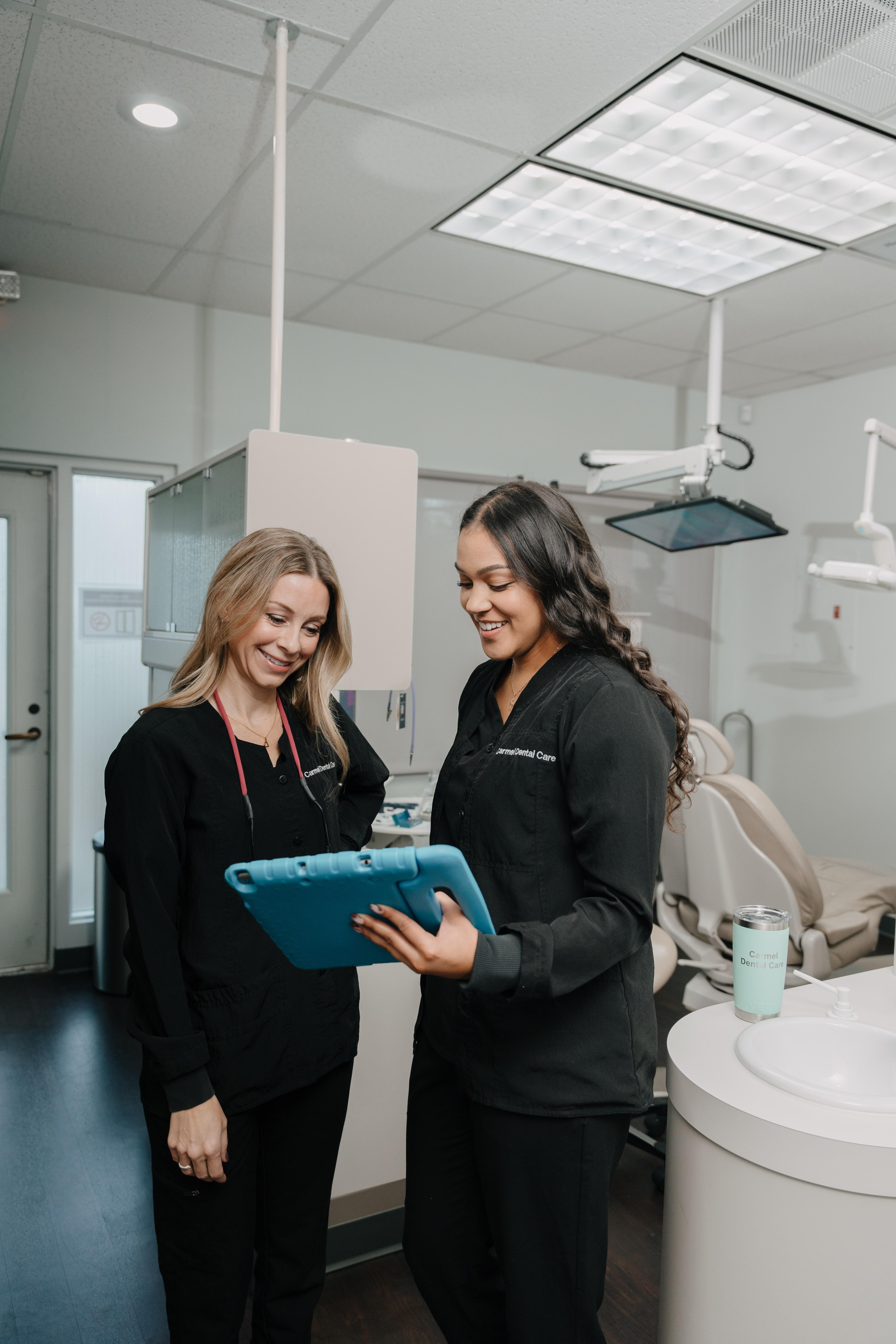 An action-packed dental procedure at Carmel Dental Care, showcasing a dentist and dental staff working together to provide exceptional oral care to a patient.